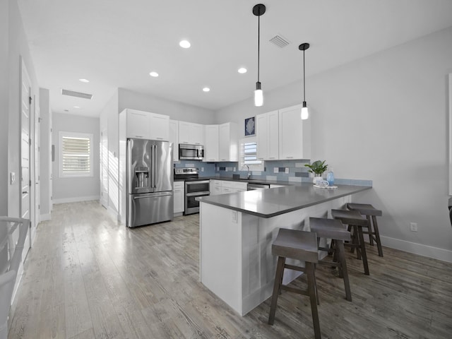5813 Rudolph Ave, Saint Augustine, FL 32080 - kitchen with a sink, visible vents, stainless steel appliances, and a peninsula