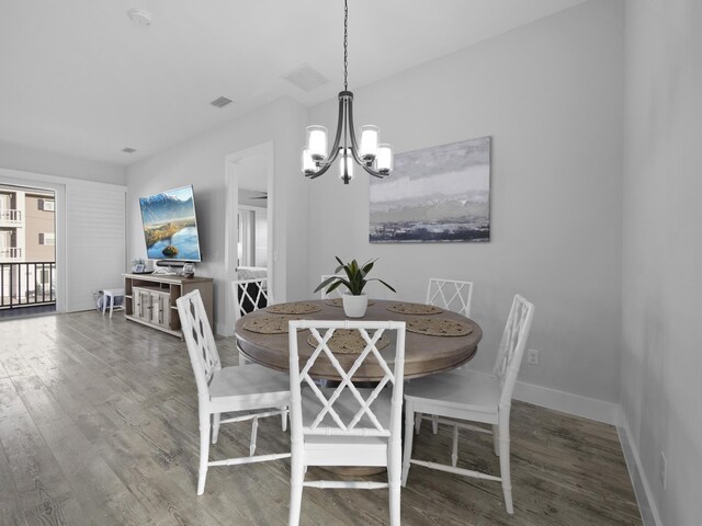 5813 Rudolph Ave, Saint Augustine, FL 32080 - dining room with visible vents, a notable chandelier, baseboards, and wood finished floors