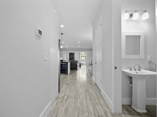 5813 Rudolph Ave, Saint Augustine, FL 32080 - corridor featuring baseboards, recessed lighting, light wood-style floors, and a sink