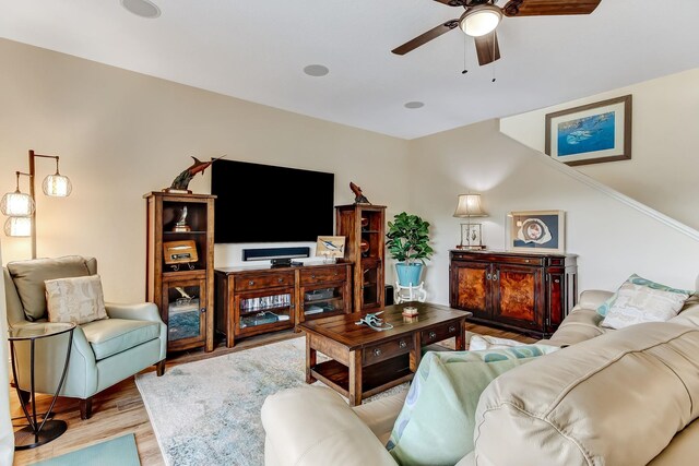 living room with hardwood / wood-style flooring and ceiling fan