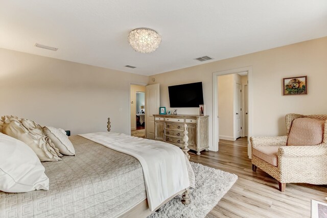 bathroom with hardwood / wood-style flooring, vanity, a textured ceiling, and tiled tub