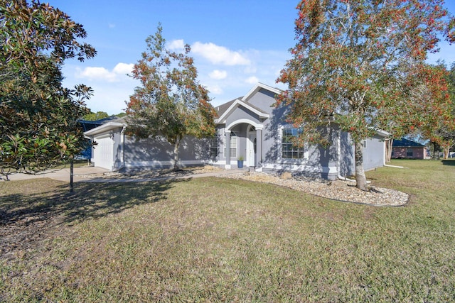 view of property hidden behind natural elements with a garage and a front yard