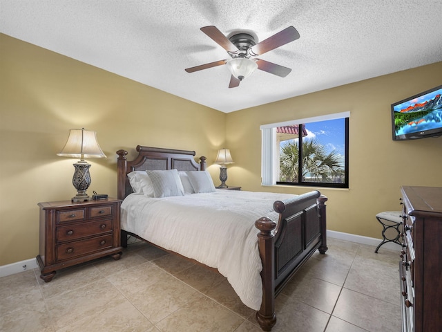 tiled bedroom featuring ceiling fan and a textured ceiling