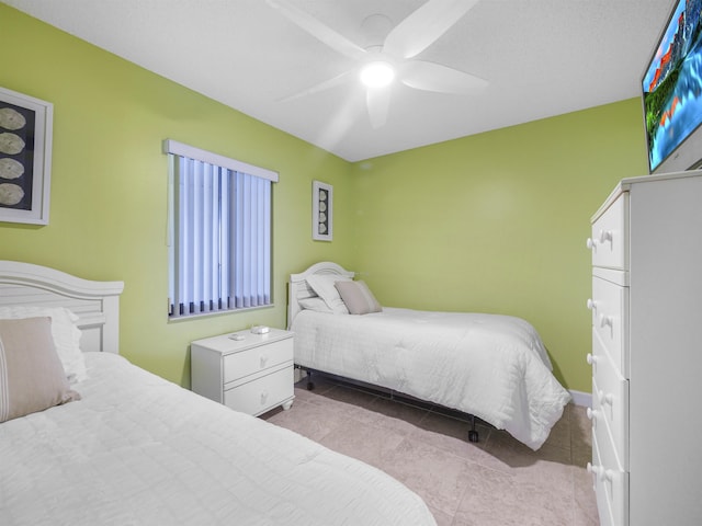 tiled bedroom featuring ceiling fan