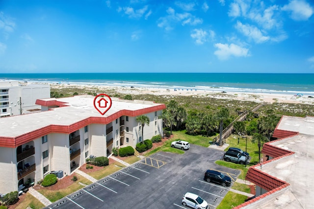 drone / aerial view with a beach view and a water view