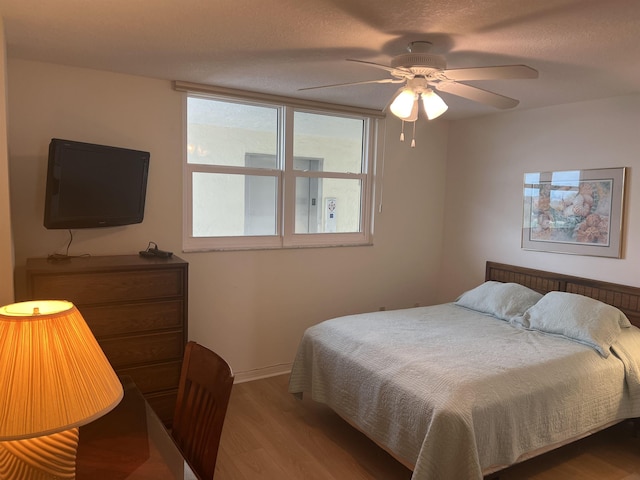 8050 A1A S Unit 205, Saint Augustine, FL 32080 - bedroom featuring light wood-style flooring, ceiling fan, and baseboards