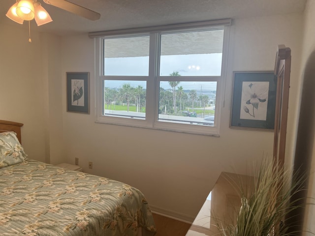 8050 A1A S Unit 205, Saint Augustine, FL 32080 - bedroom with wood finished floors, a ceiling fan, and baseboards