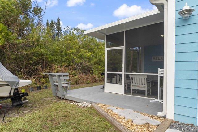 view of yard with a deck and a sunroom