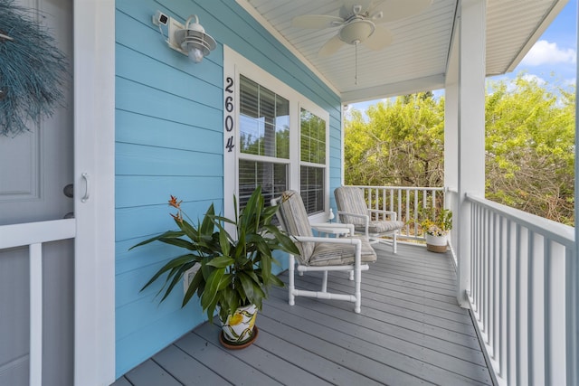 wooden terrace featuring ceiling fan