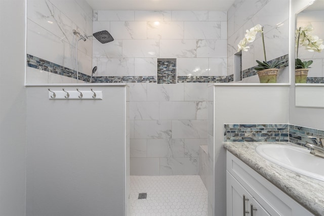 bathroom featuring vanity and tiled shower