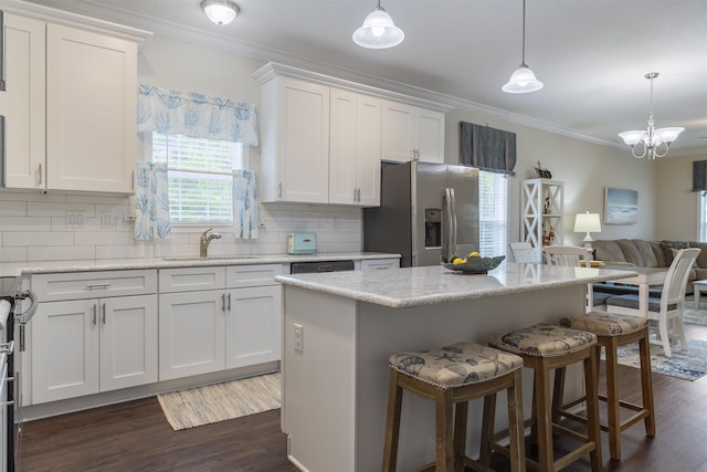 kitchen with white cabinets, sink, hanging light fixtures, dark hardwood / wood-style flooring, and stainless steel fridge with ice dispenser