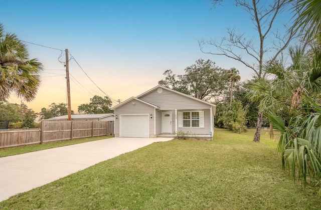 view of front of property featuring a lawn and a garage