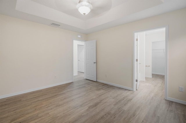 spare room featuring light hardwood / wood-style flooring and ceiling fan