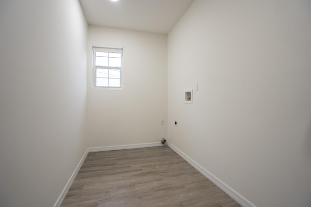 laundry area with hookup for an electric dryer, hookup for a washing machine, and light hardwood / wood-style flooring