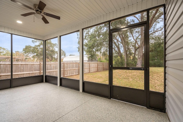 unfurnished sunroom featuring ceiling fan