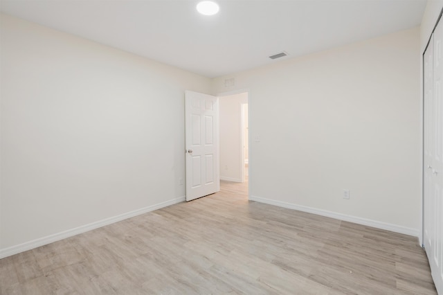 unfurnished room with light hardwood / wood-style floors