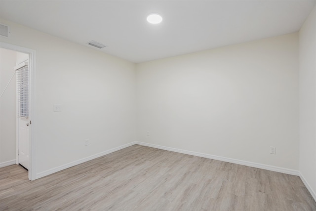 spare room with light hardwood / wood-style flooring