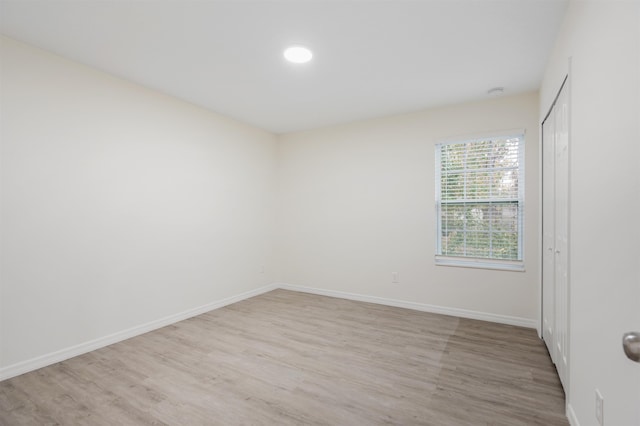 empty room with light hardwood / wood-style floors