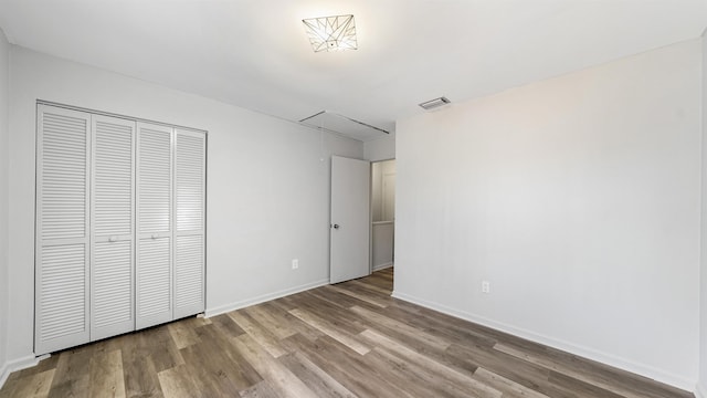 unfurnished bedroom featuring a closet and light hardwood / wood-style flooring