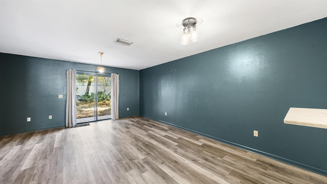 unfurnished room featuring wood-type flooring