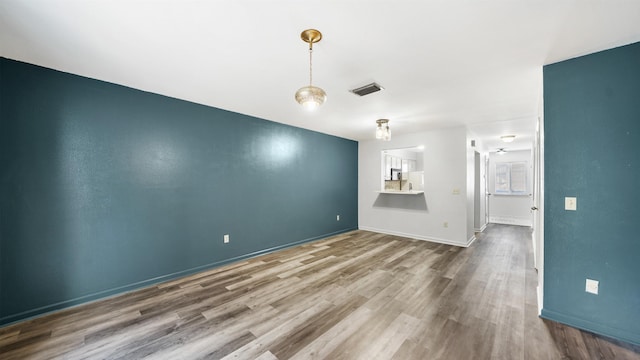 unfurnished living room featuring hardwood / wood-style flooring