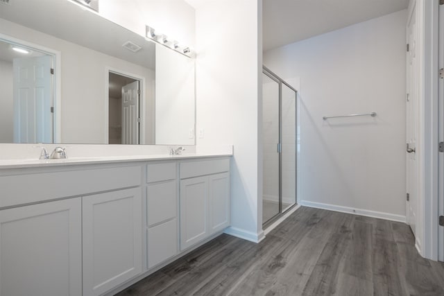 638 Honeycomb Trl, Saint Augustine, FL 32095 - full bath featuring double vanity, a sink, a stall shower, and wood finished floors