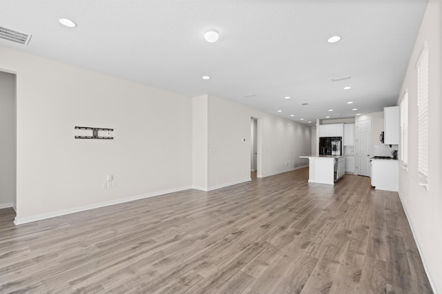 638 Honeycomb Trl, Saint Augustine, FL 32095 - unfurnished living room with recessed lighting, baseboards, light wood finished floors, and visible vents