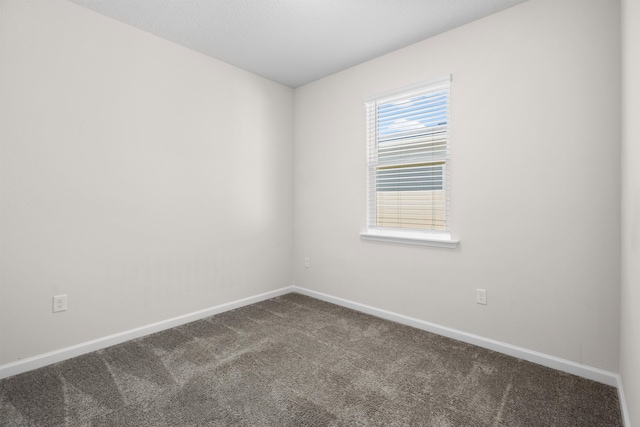 638 Honeycomb Trl, Saint Augustine, FL 32095 - spare room with baseboards and dark colored carpet