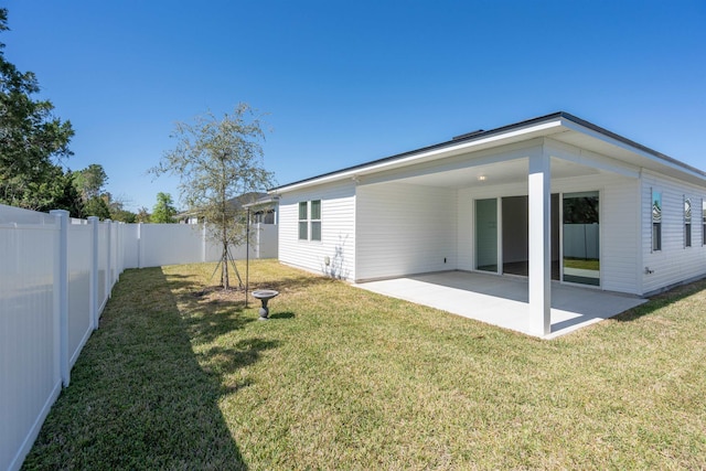 638 Honeycomb Trl, Saint Augustine, FL 32095 - rear view of house featuring a fenced backyard, an attached carport, a lawn, and a patio area