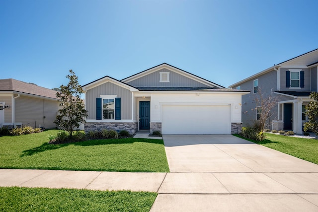 638 Honeycomb Trl, Saint Augustine, FL 32095 - view of front of home with concrete driveway, an attached garage, stone siding, board and batten siding, and a front lawn