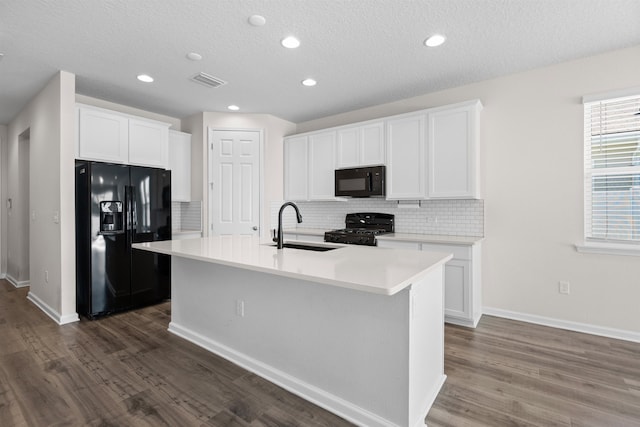 638 Honeycomb Trl, Saint Augustine, FL 32095 - kitchen with visible vents, dark wood finished floors, white cabinetry, a sink, and black appliances