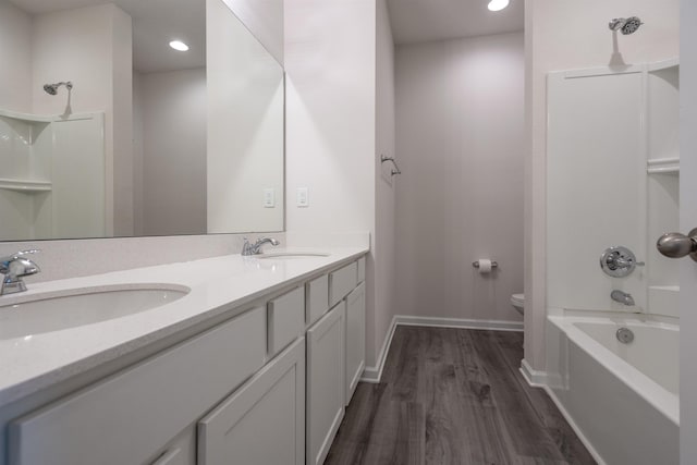 638 Honeycomb Trl, Saint Augustine, FL 32095 - full bathroom featuring toilet, a sink, double vanity, and wood finished floors