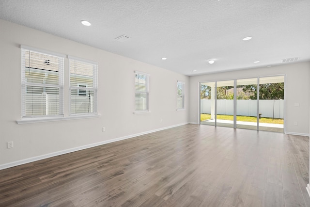 638 Honeycomb Trl, Saint Augustine, FL 32095 - empty room featuring baseboards, visible vents, wood finished floors, and a textured ceiling