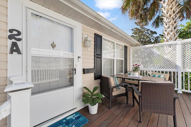 deck with outdoor dining area