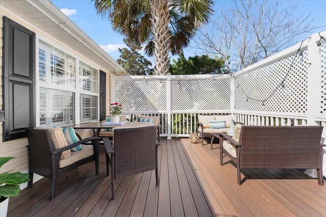 wooden terrace featuring an outdoor hangout area and outdoor dining space