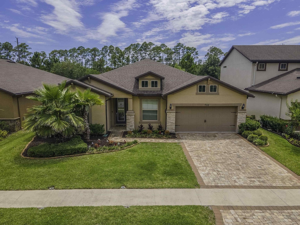 view of front of house featuring a front yard and a garage