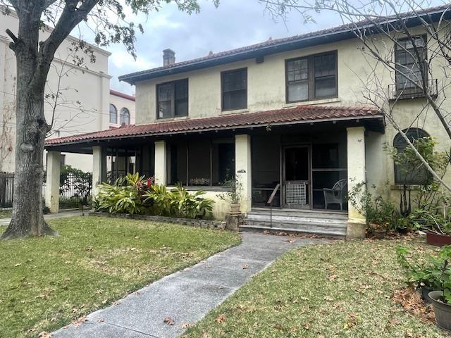 rear view of house featuring a yard