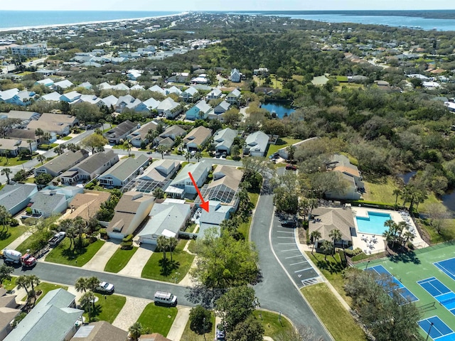 drone / aerial view with a residential view and a water view