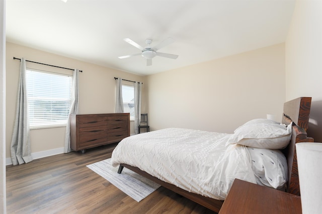 bedroom with wood finished floors, baseboards, and ceiling fan