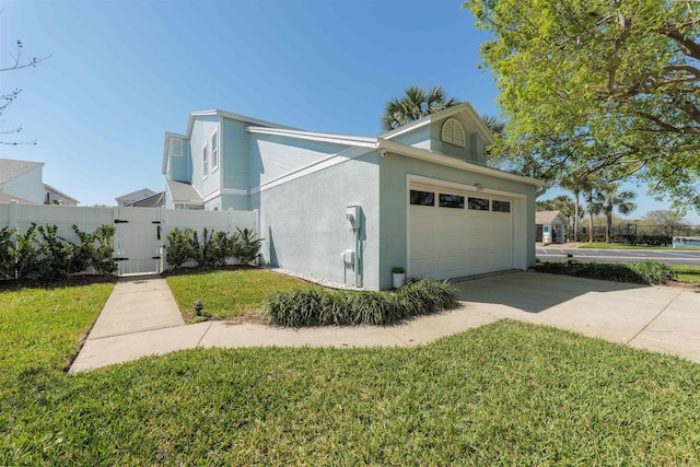 view of property exterior with a gate, fence, an attached garage, stucco siding, and a lawn