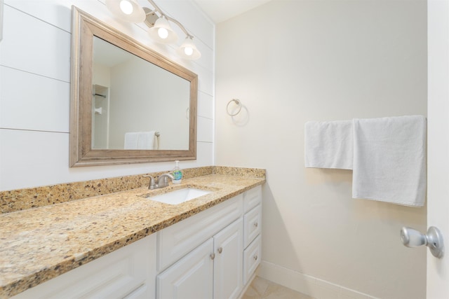 bathroom with baseboards and vanity