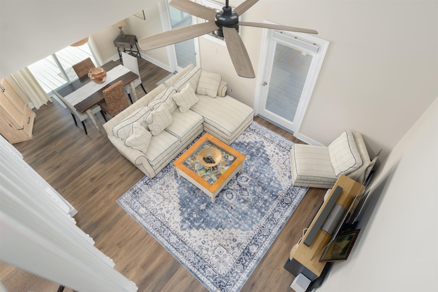 living room featuring wood finished floors and a ceiling fan