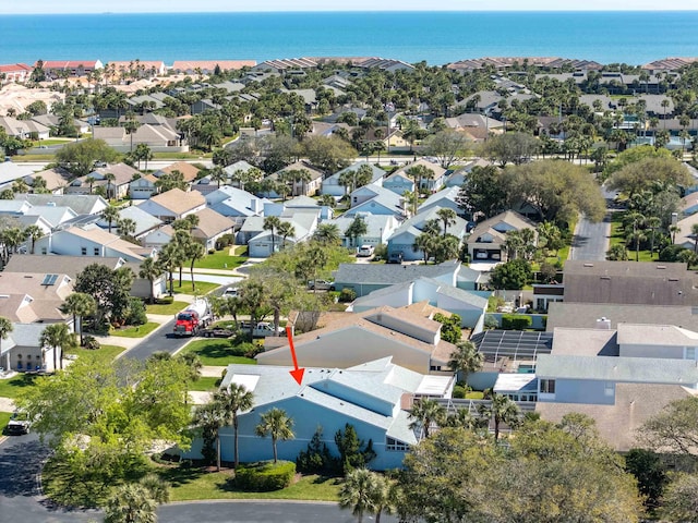 drone / aerial view with a residential view and a water view