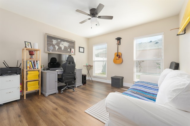 home office featuring baseboards, dark wood-type flooring, and a ceiling fan