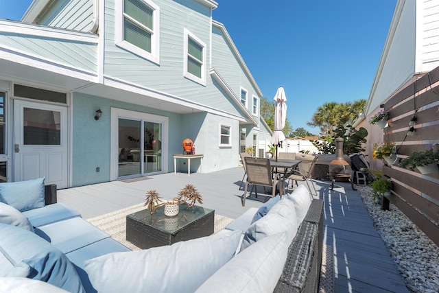 view of patio / terrace featuring a wooden deck, outdoor dining space, and outdoor lounge area