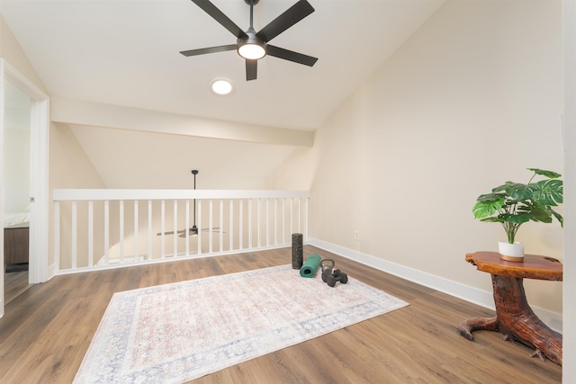 exercise room with lofted ceiling, wood finished floors, recessed lighting, baseboards, and ceiling fan