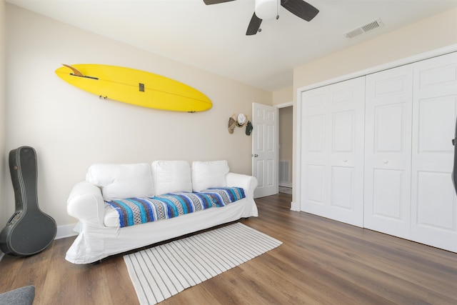 bedroom featuring wood finished floors, visible vents, a closet, and ceiling fan