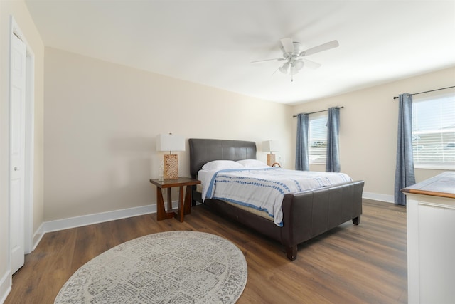 bedroom featuring wood finished floors, baseboards, and ceiling fan