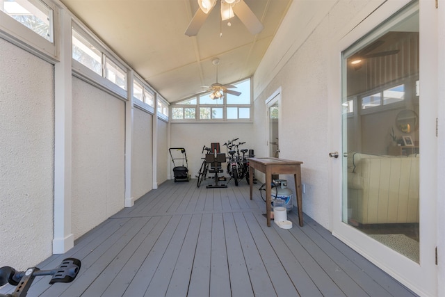 sunroom featuring a ceiling fan and vaulted ceiling