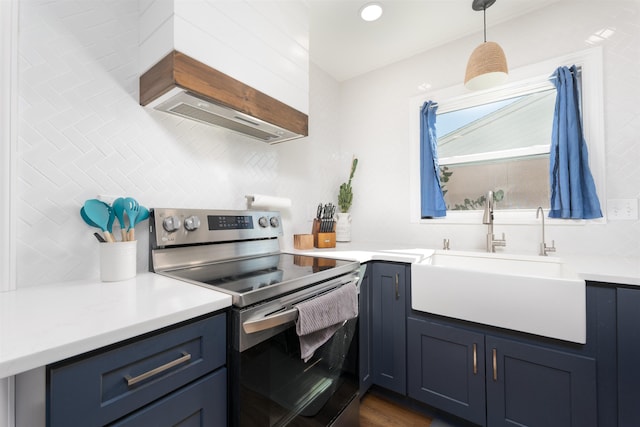 kitchen with a sink, blue cabinets, tasteful backsplash, and stainless steel electric stove